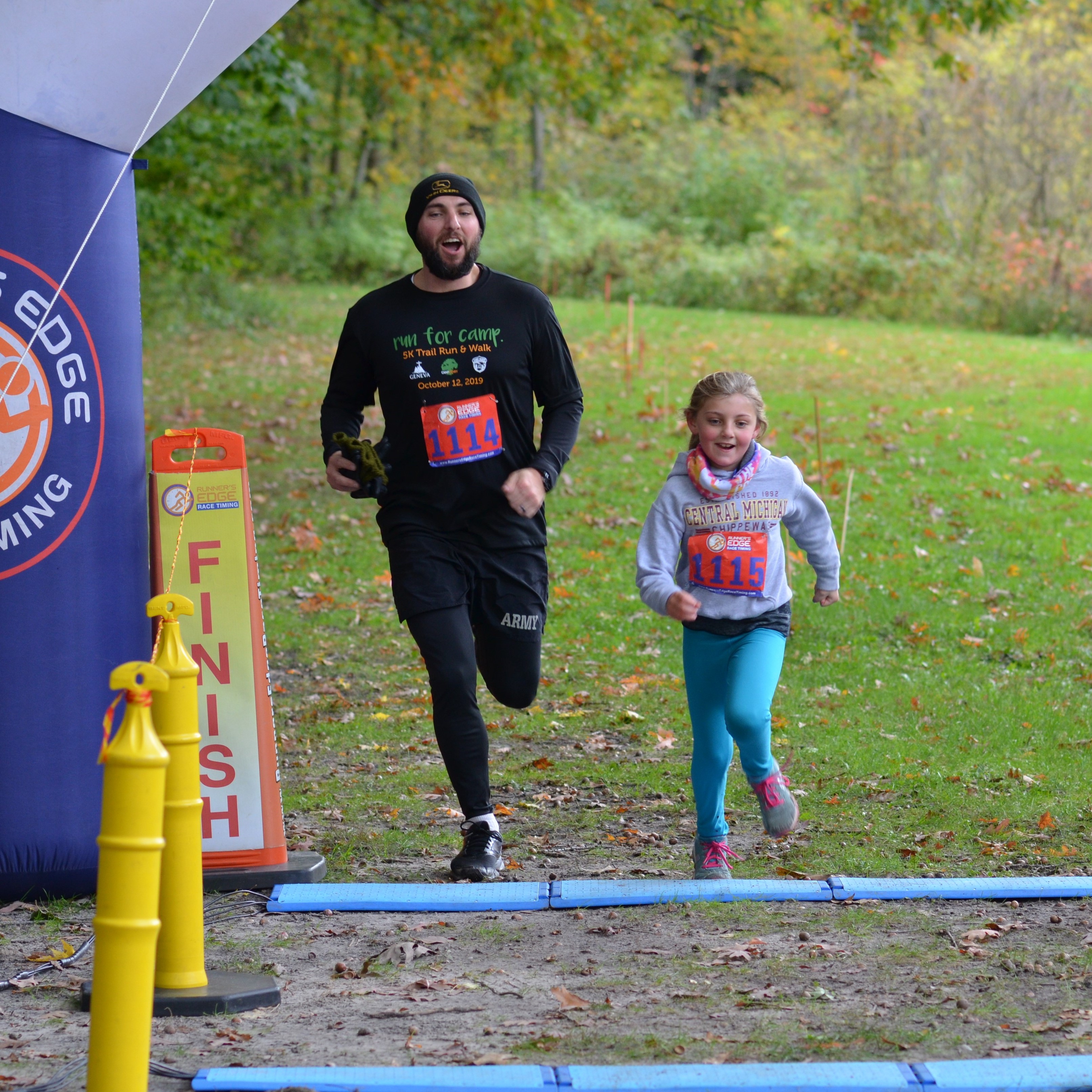 Son and daughter crossing the finish line at the Camp Henry Run for Camp 5K